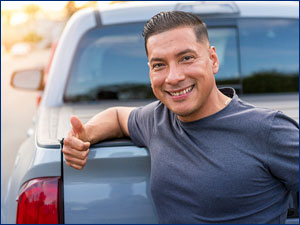 man standing behind pick up truck