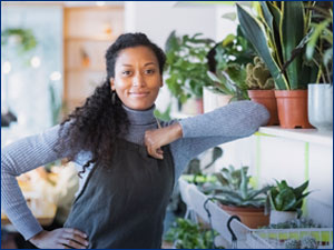 woman standing next to plants