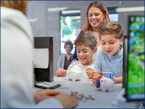 woman and two boys cashing out piggy banks