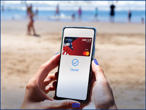 person holding mobile phone with RBFCU debit card on screen