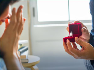 person holding engagement ring in ring case