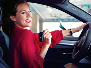 woman sitting in car holding car key