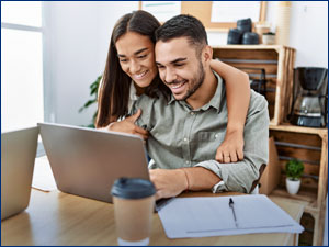 man and woman looking at laptop