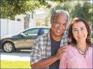 man and woman in front of car