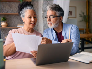 man and woman sitting at table reviewing documents