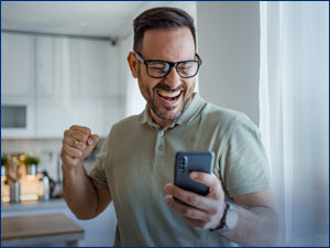 Man excited while holding a phone