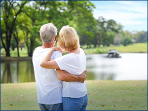 Couple hugging while looking out at a lake
