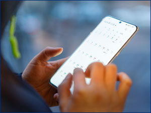 person looking and calendar app in mobile phone
