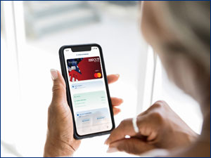 Person looking at a RBFCU debit card on their phone.