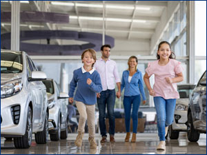 Family in a car dealership