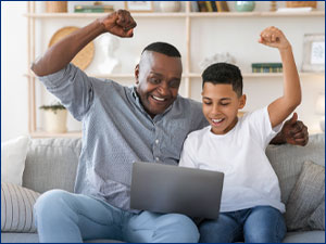 Father and son looking at a computer
