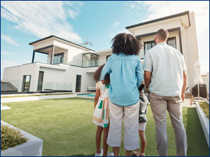 Family standing outside of a house