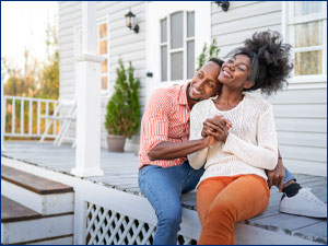 couple hugging in front of home