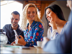 Women showing friends her phone
