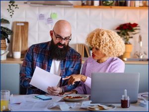man and woman looking through documents