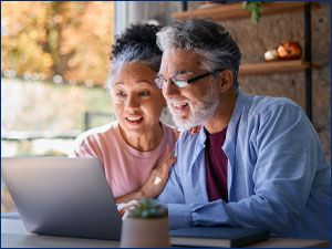 man and woman looking at laptop