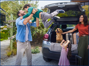 Family and dog next to a car. 
