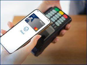 Person using their phone with the RBFCU Mastercard to pay. 