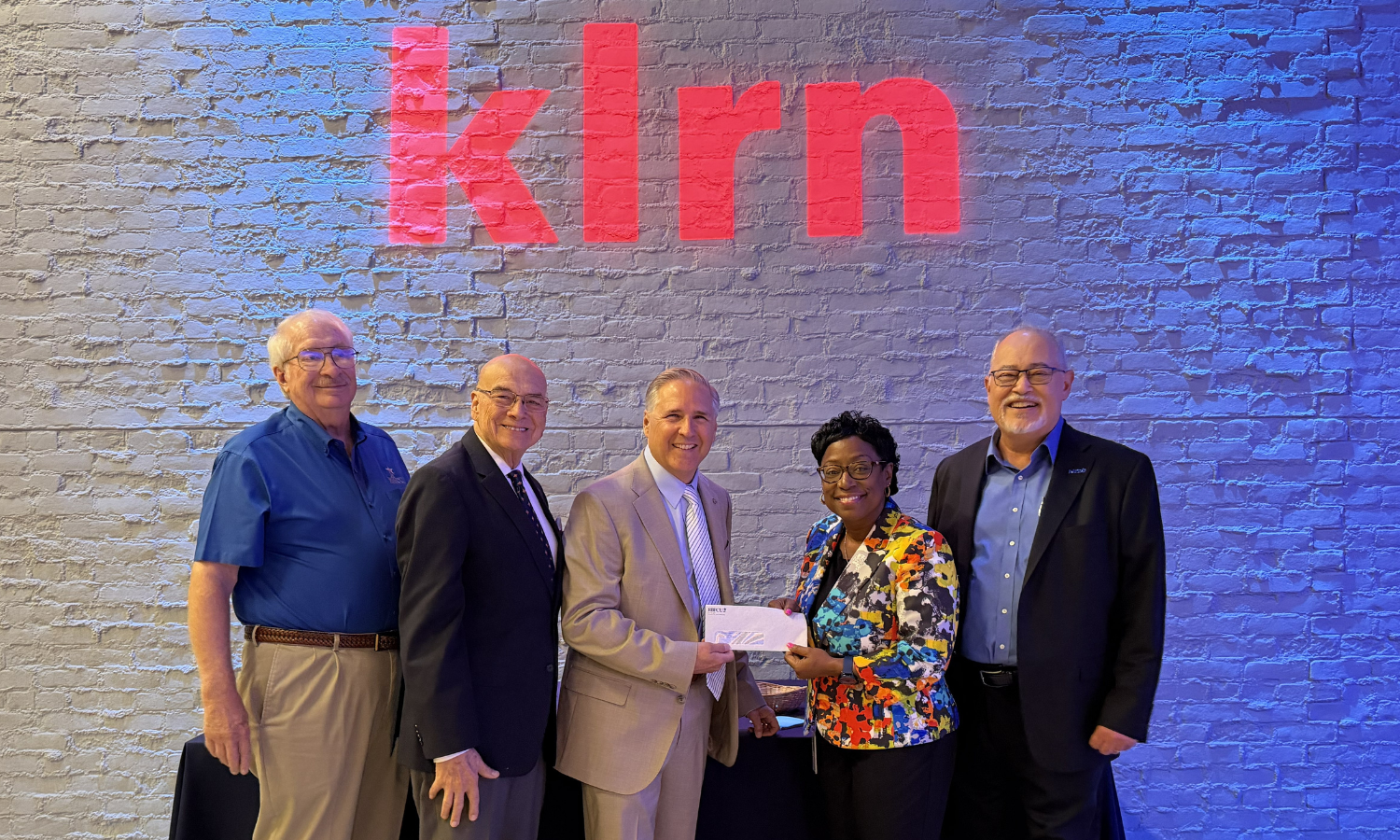 KLRN check donation from RBFCU.