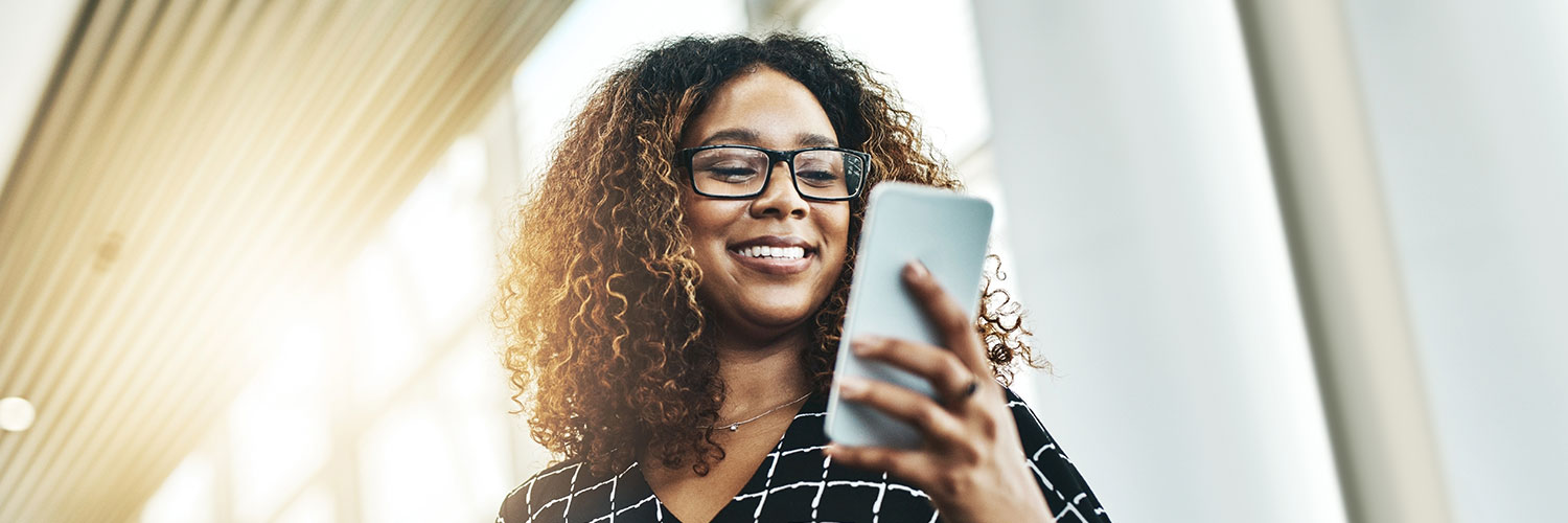 103-19-deposits-getpaidearly-hero-image Woman smiling while checking smartphone