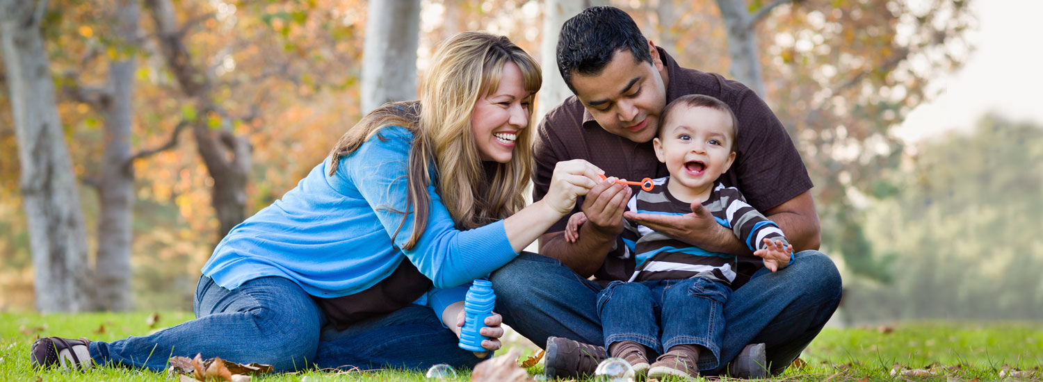 Become-a-Member-Hero-Image-Final Parents playing with their child at a park