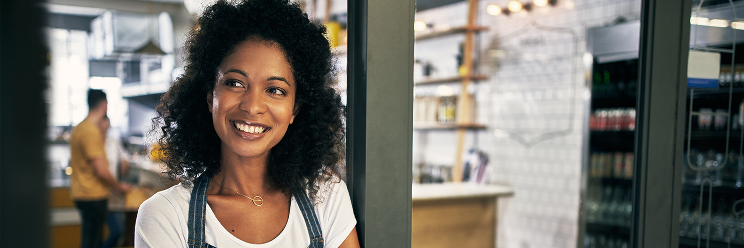 Business Loans Woman smiling at her place of work