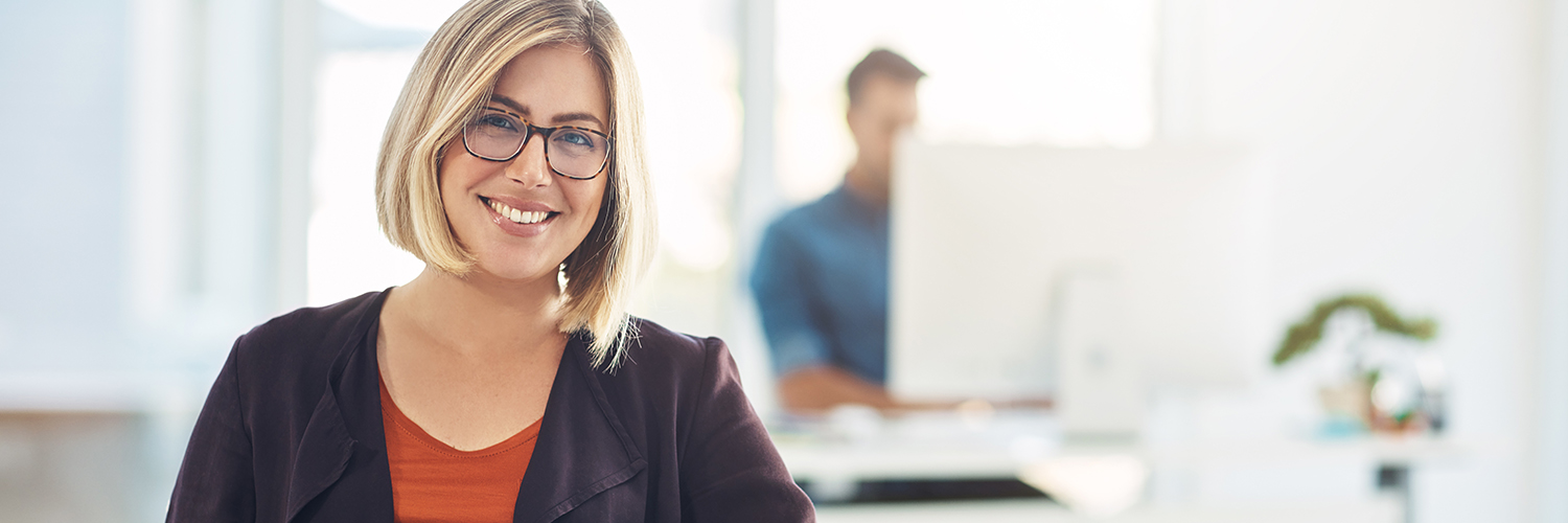 Business Solutions Woman smiling at her place of work