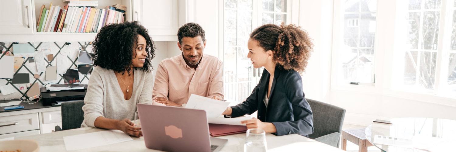 Homebuying-and-Selling-Services-Hero Couple talking to a professional inside their home