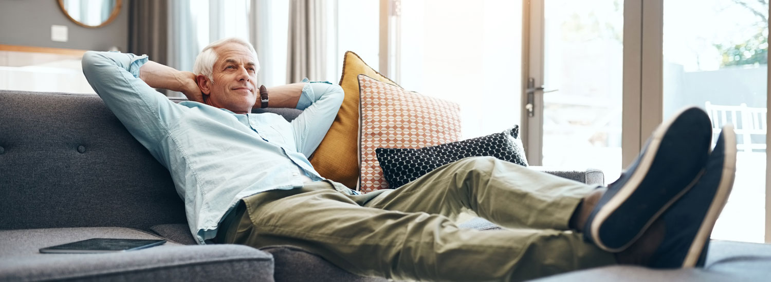 Identity-Theft-Coverage-Hero-ImageFinal A man relaxing on the couch