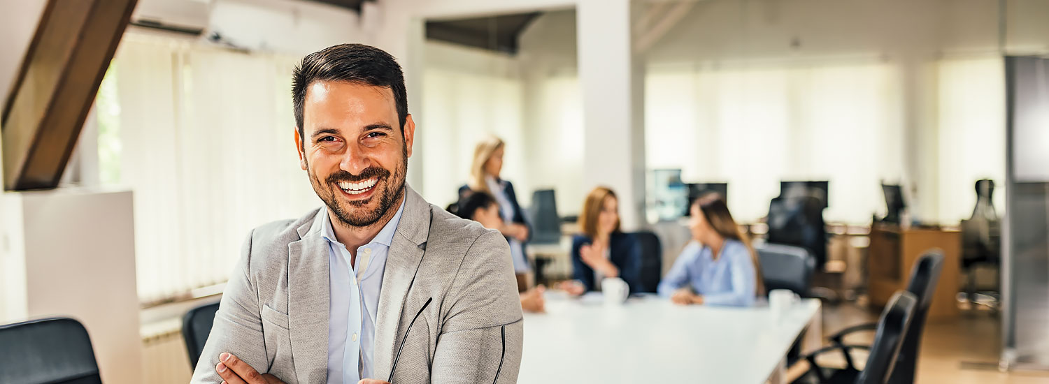 INS-AGNCY-Half-Hero-Commercial-FIN Man at work standing in front of table