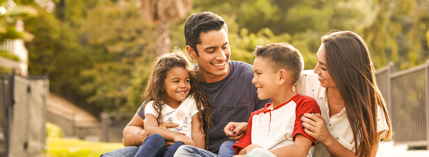 INS-AGNCY-Half-Hero-Insurance-Agency-FIN Family of four sitting together outside
