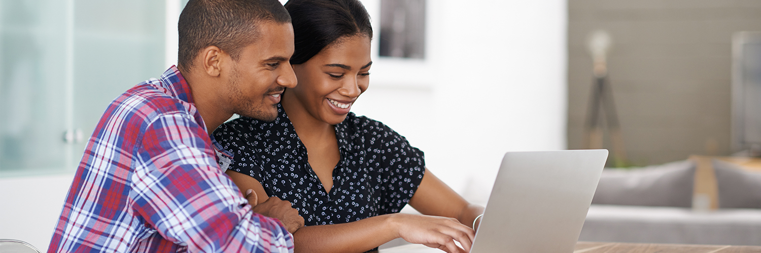 Learn A couple looking at a laptop