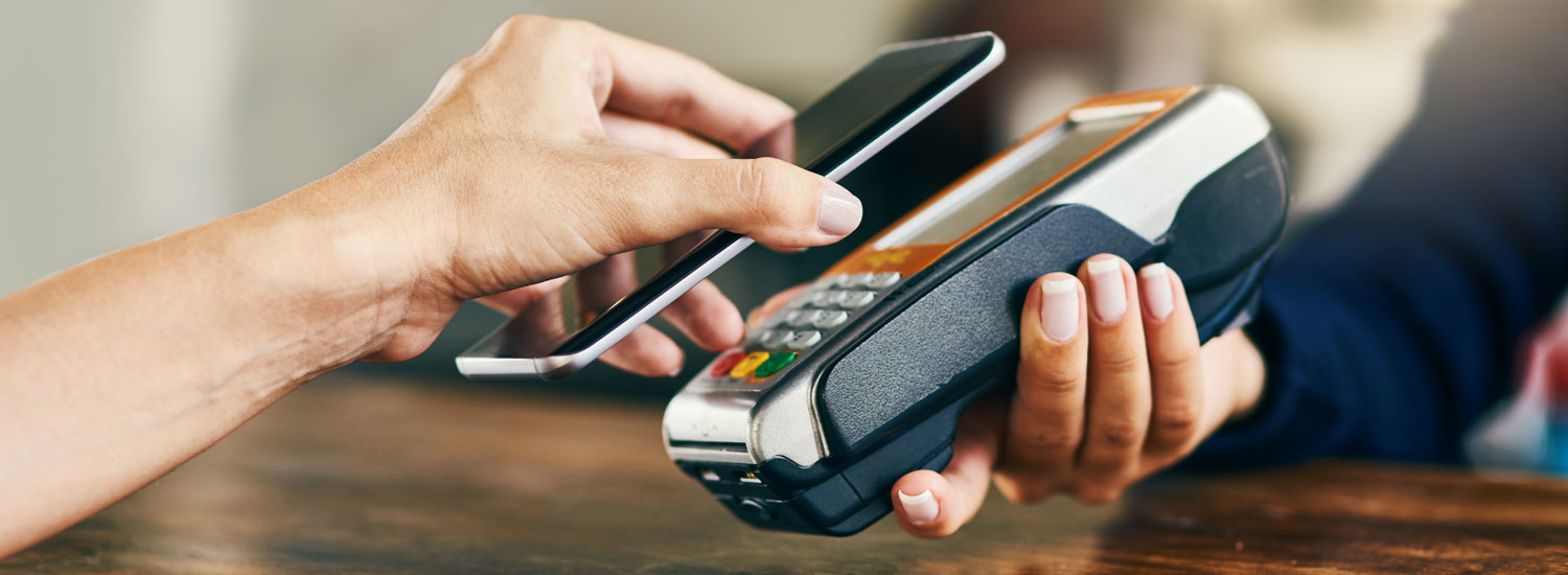 Mobile-Payment-Services-Hero-ImageFinal A person paying with their mobile payment service