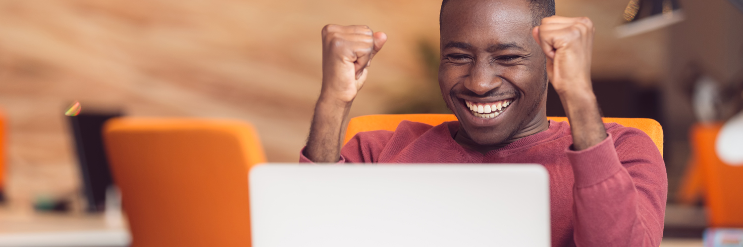 Personal Loans Excited person looking at computer screen