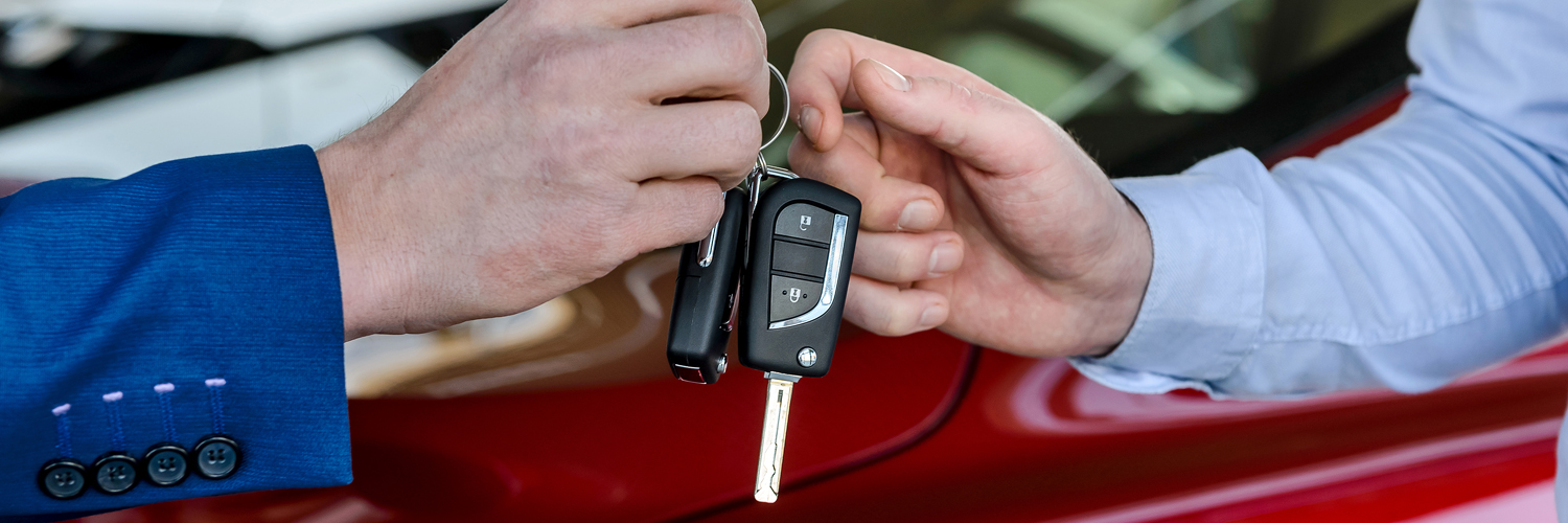 Preferred Dealers Person handing someone else keys to car