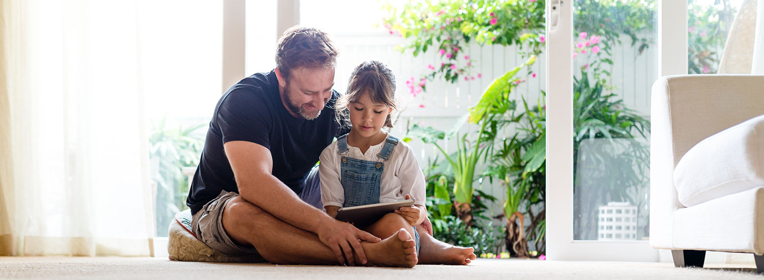 RBFCU Services-Hero-Image Father and daughter using tablet device.