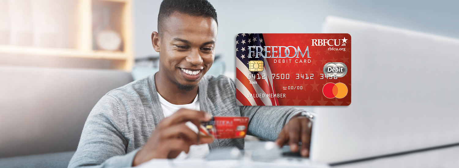 Really-Free-Checking-Hero-ImageFinal Man holding RBFCU Freedom Debit Card