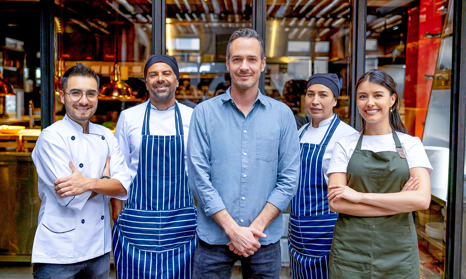 group of people wearing chef jacket and aprons