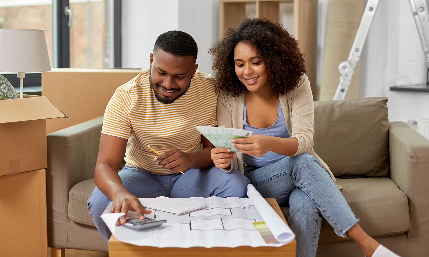 Man and woman looking at paint samples and using calculator
