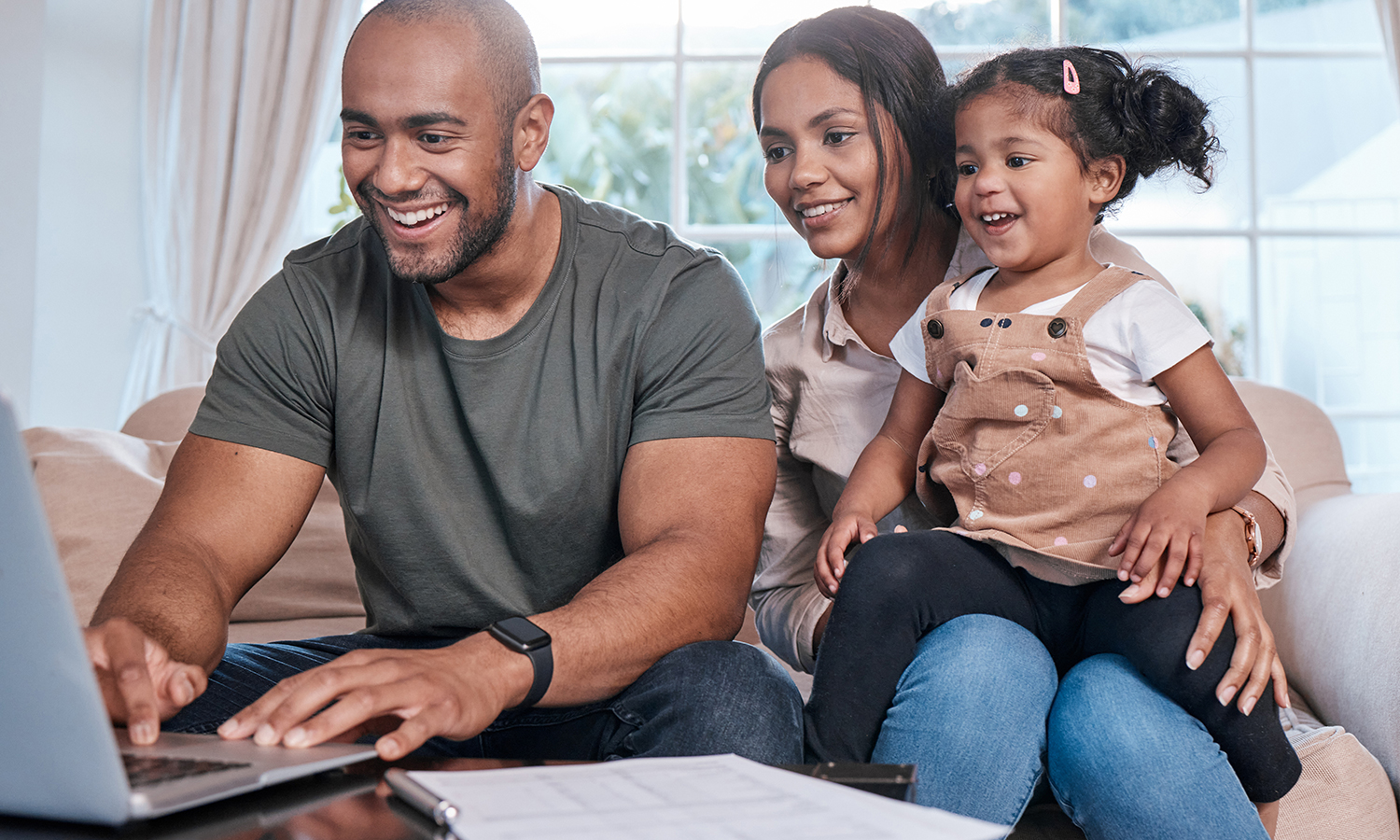 Man, woman and girl reviewing credit reports on laptop