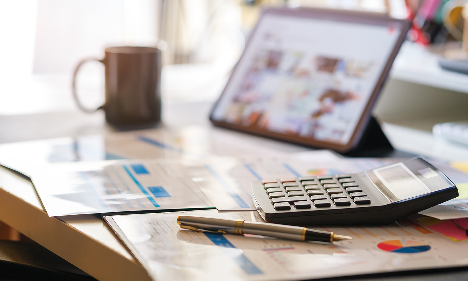 Calculator and charts with credit scores on table
