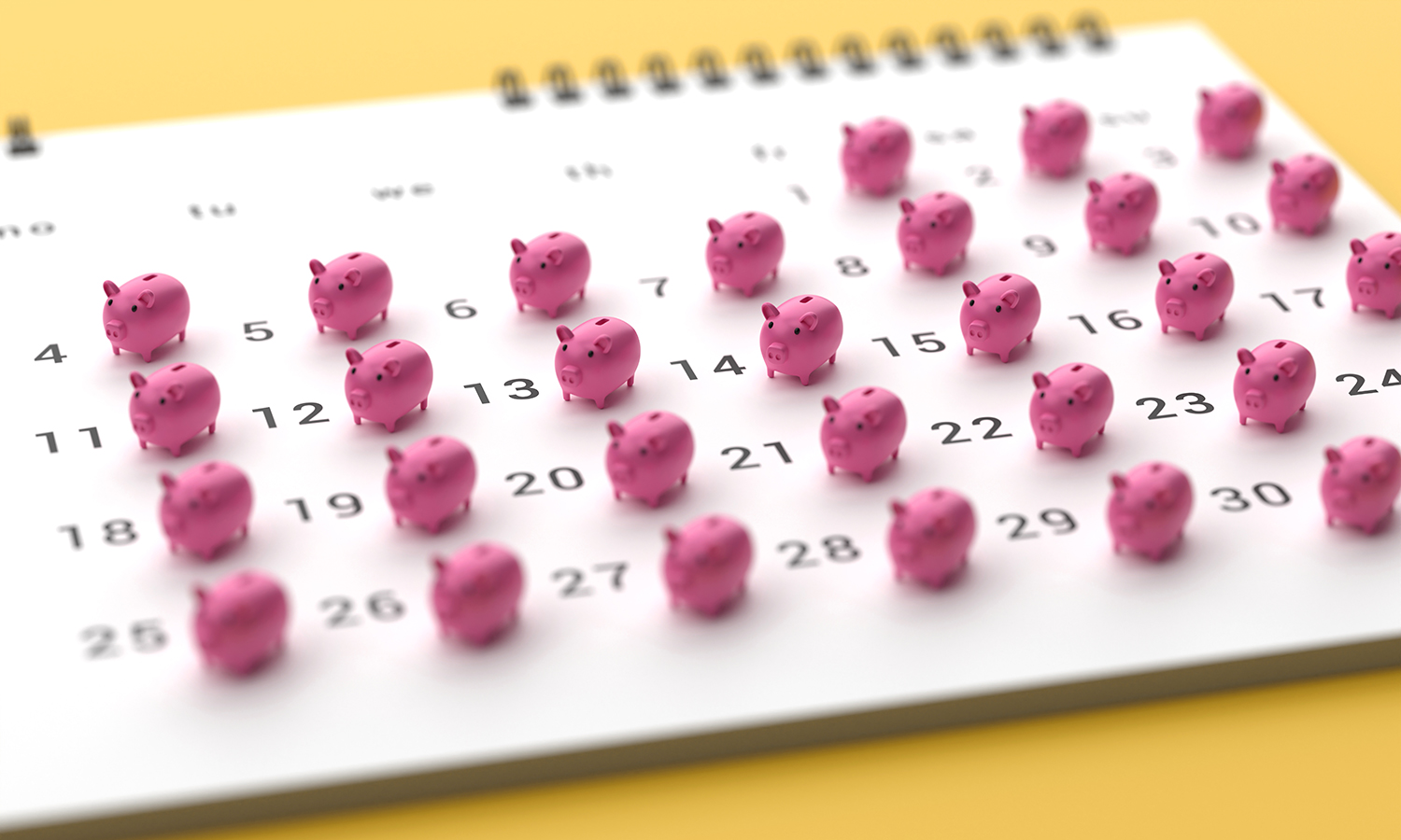 Piggy banks sitting on 30 days of a calendar