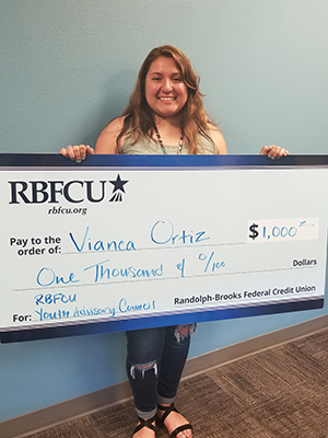 RBFCU Youth Advisory Council member Vianca Ortiz, a senior at East Central High School, is presented with a scholarship.
