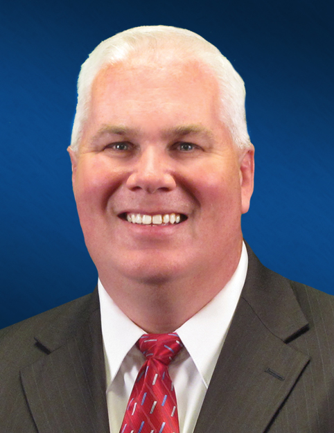 an image of David Stanley with a grey suit and a red tie