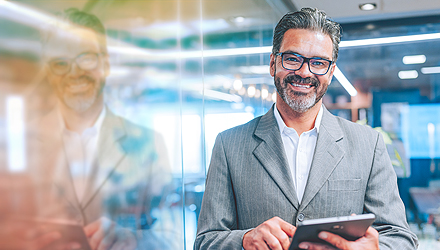 man holding a tablet and wearing a suit