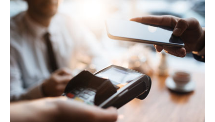 Person using smartphone to make a payment Person using smartphone to make a payment
